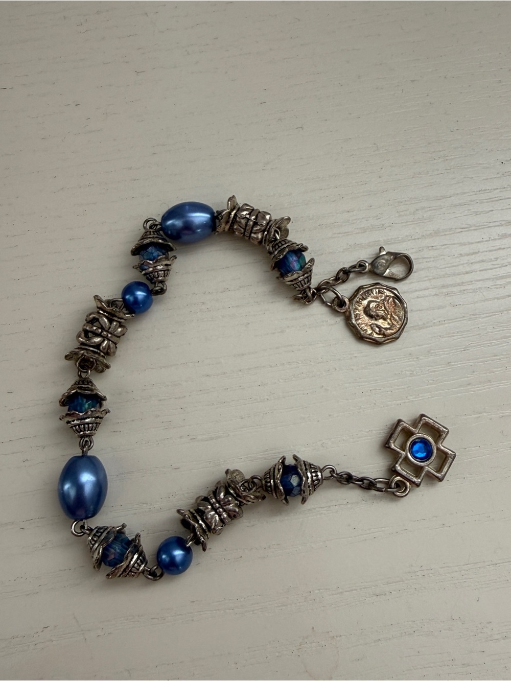 Blue pearl and silver charm bracelet with blue beads and silver charms